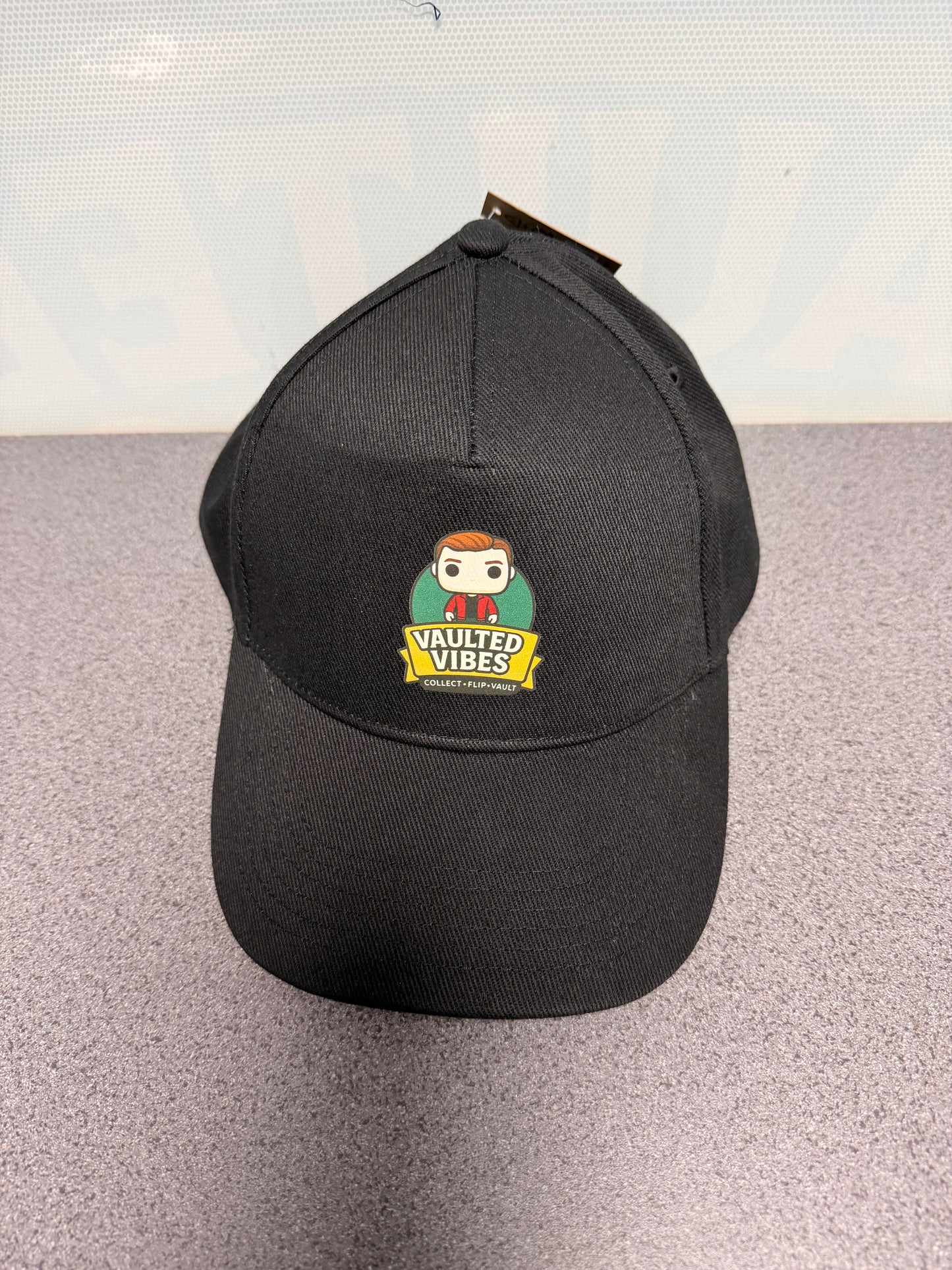 Official black Vaulted Vibes baseball cap with full-colour mascot logo, front view