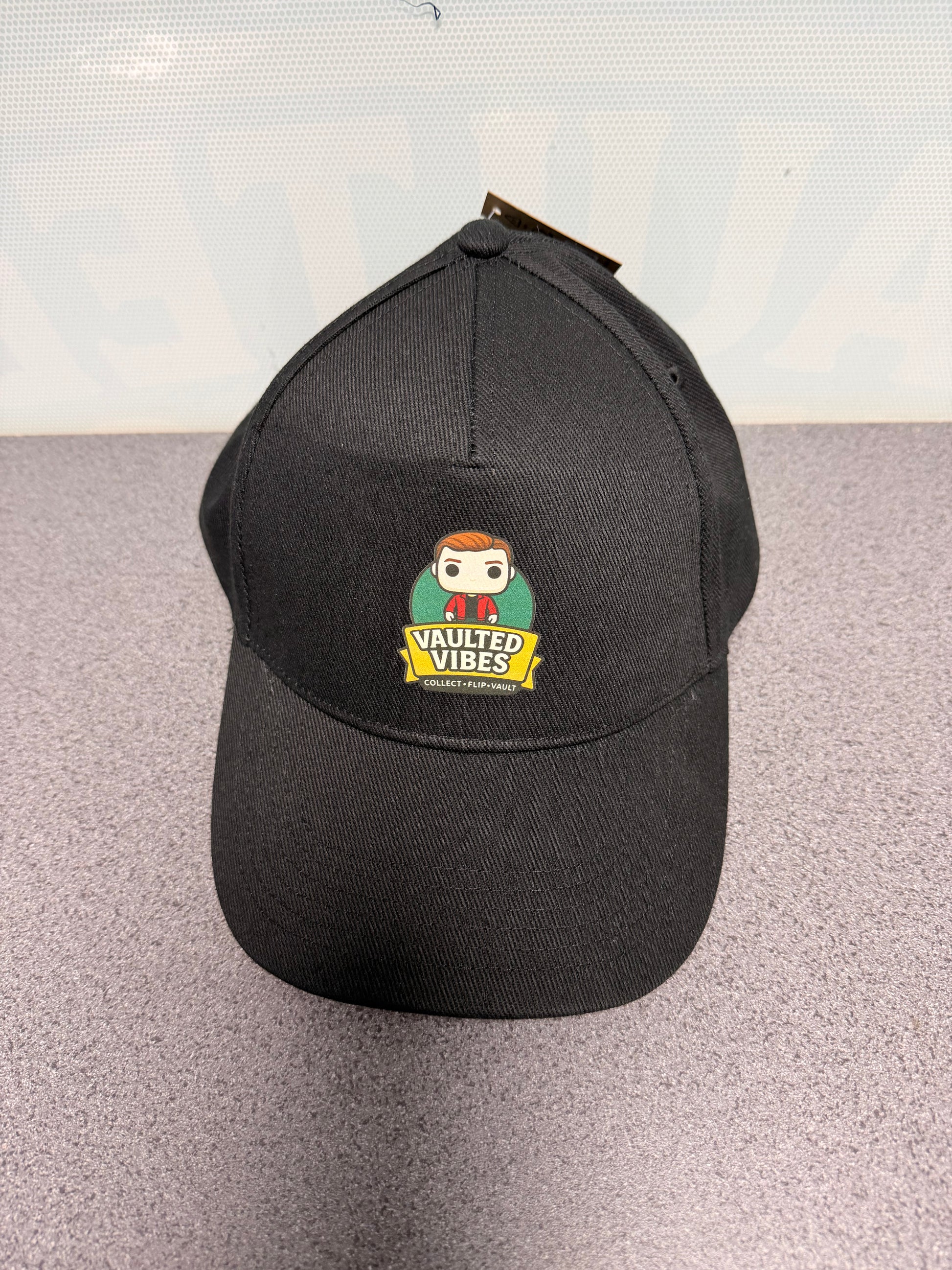 Official black Vaulted Vibes baseball cap with full-colour mascot logo, front view