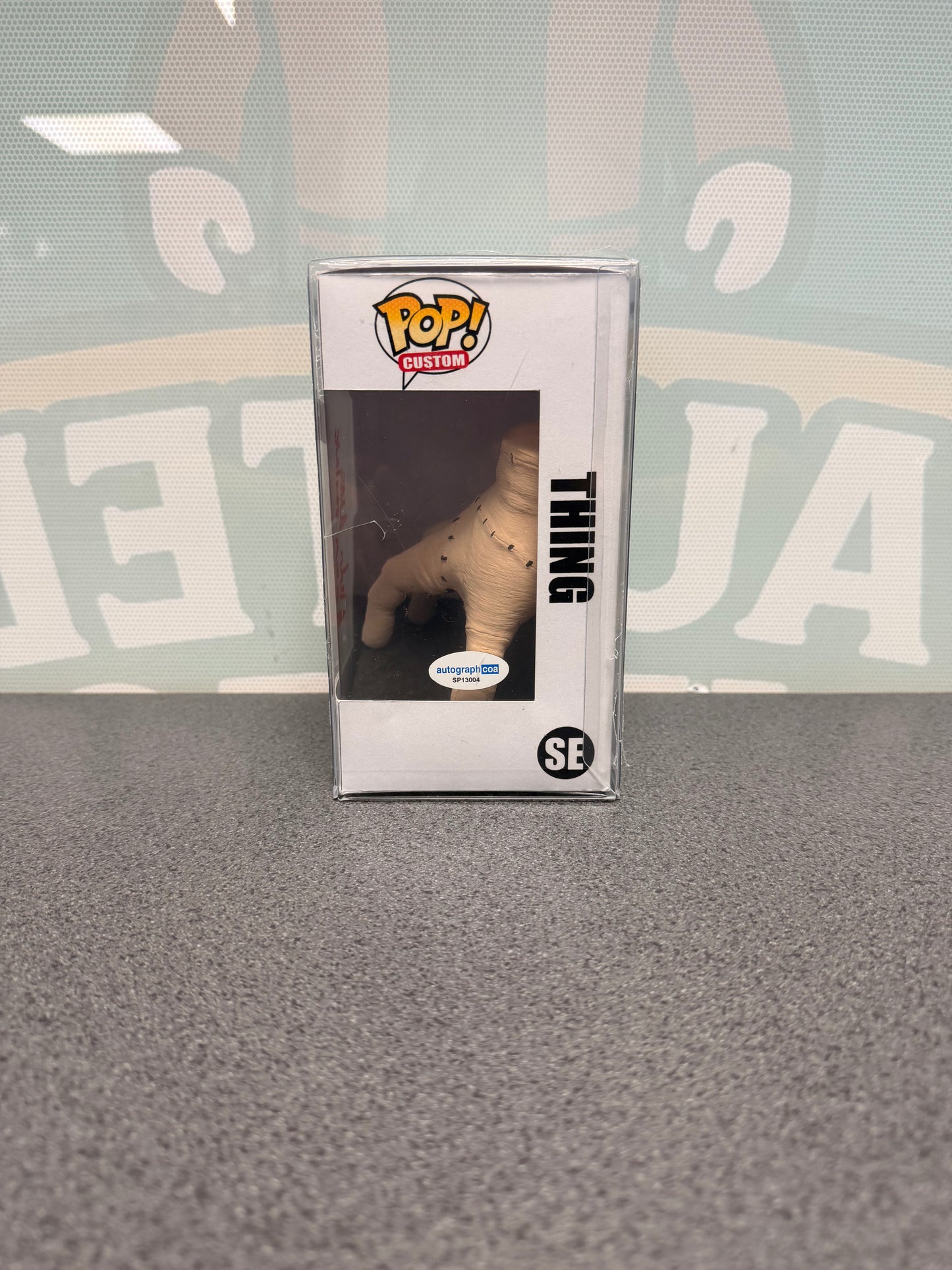 Thing custom figure SE – window side of box with ACOA sticker