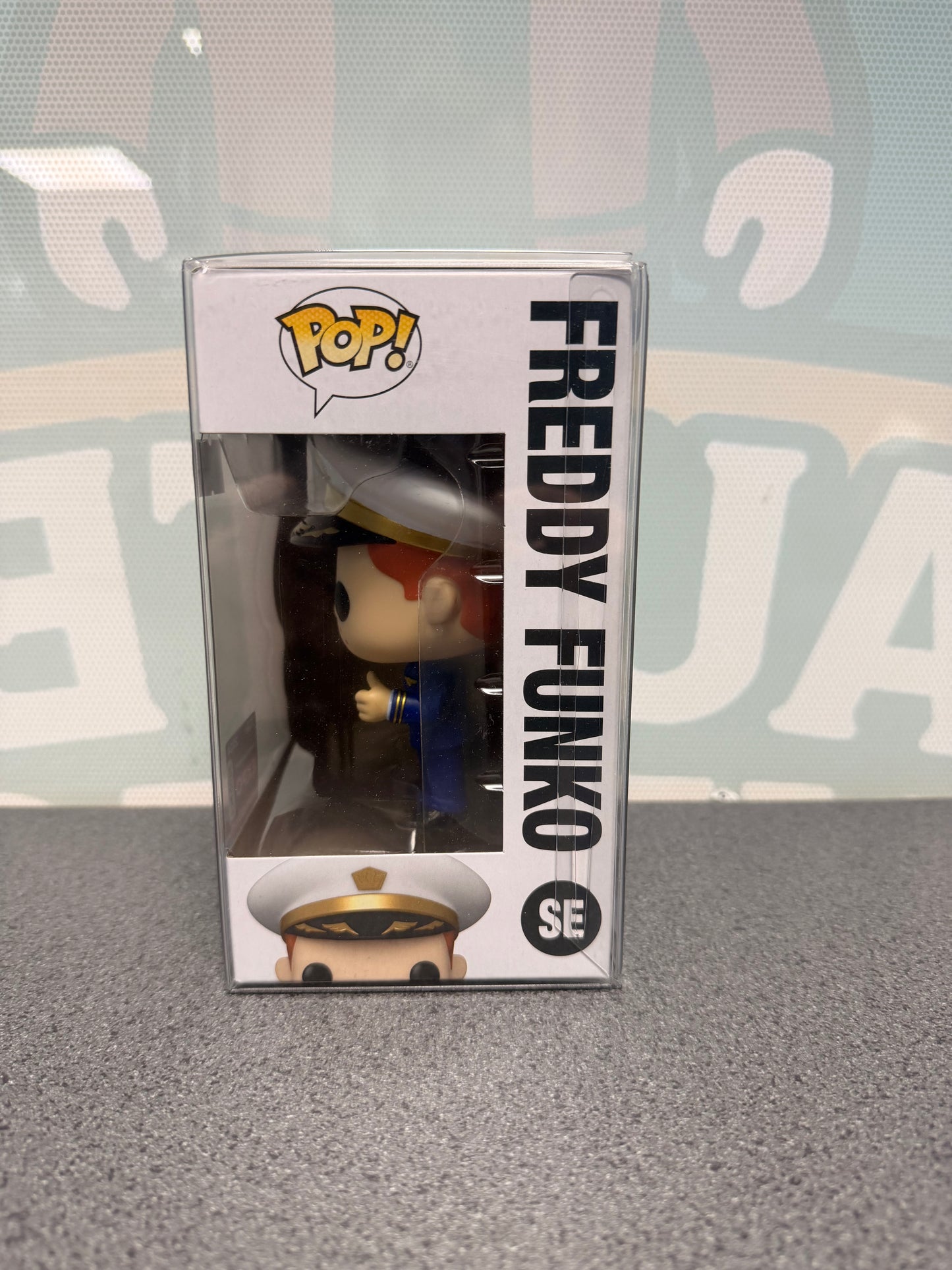 Window side of Freddy Funko Pilot Pop! SE showing the white pilot's cap and navy uniform.