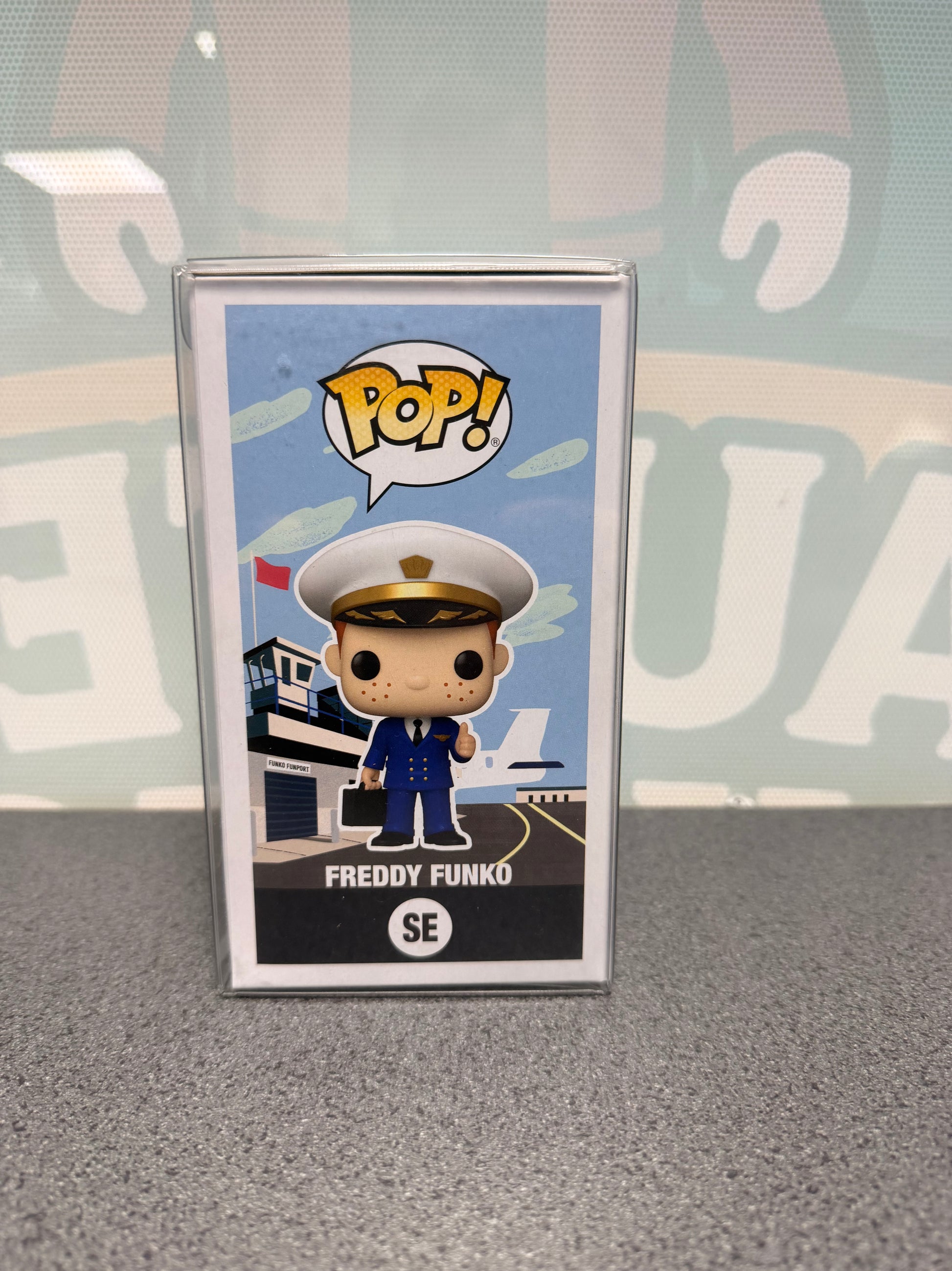 Illustrated side of Freddy Funko Pilot Pop! SE with the character in front of an airport.