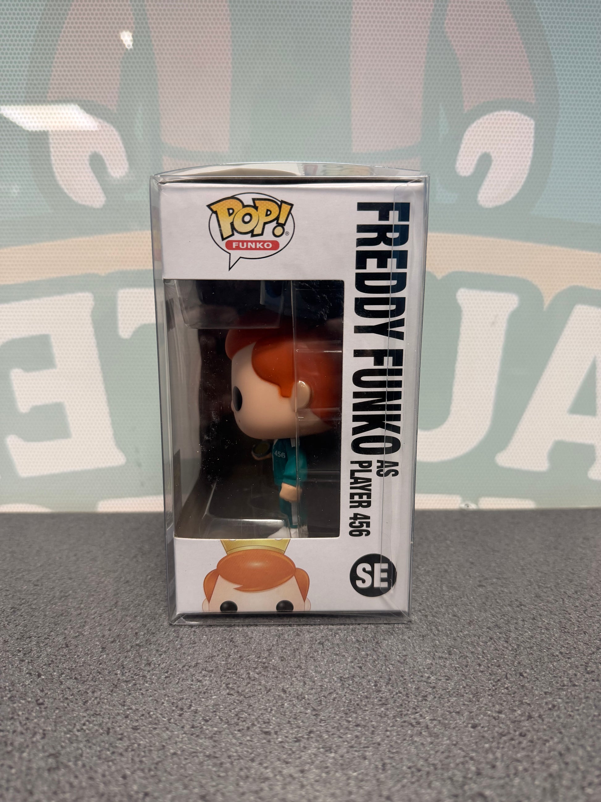 Window side of Freddy Funko as Player 456 Pop! SE showing the figure in profile.