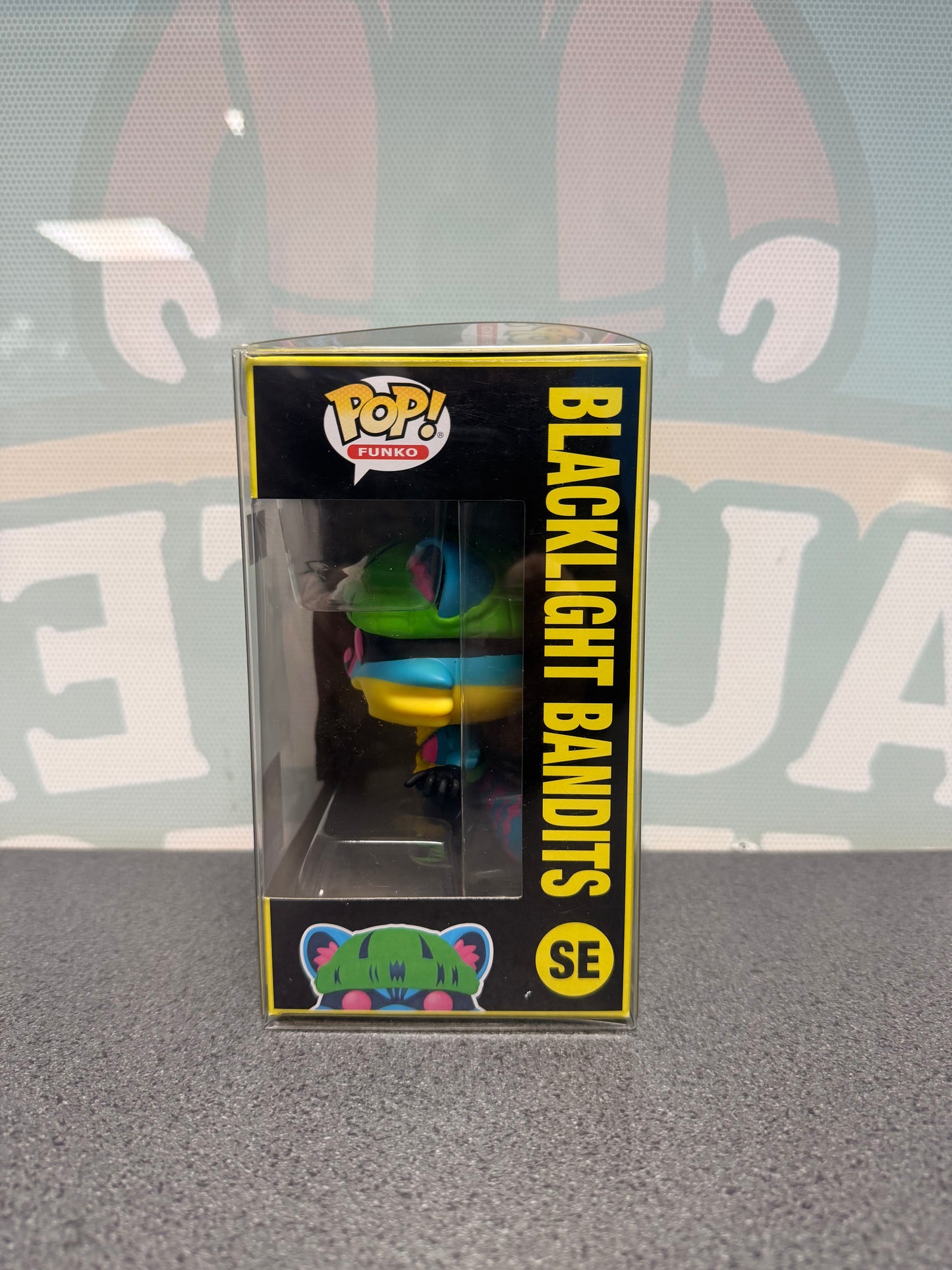 Window side of the Blacklight Bandits Funko Pop! SE box showing the mascot's green hat.