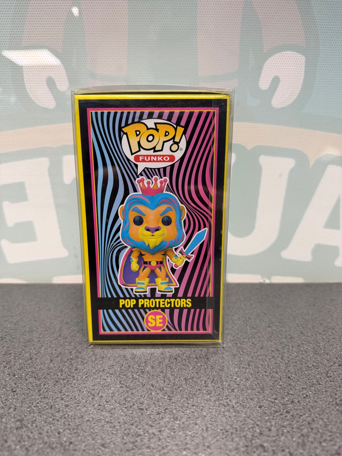 Illustrated side of the Pop Protectors Funko Pop! SE box with the crowned lion and sword.