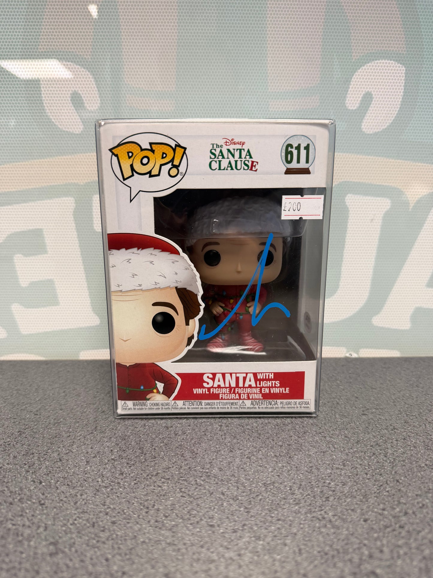Santa with Lights Funko Pop! #611 box front, with a Tim Allen autograph in blue ink