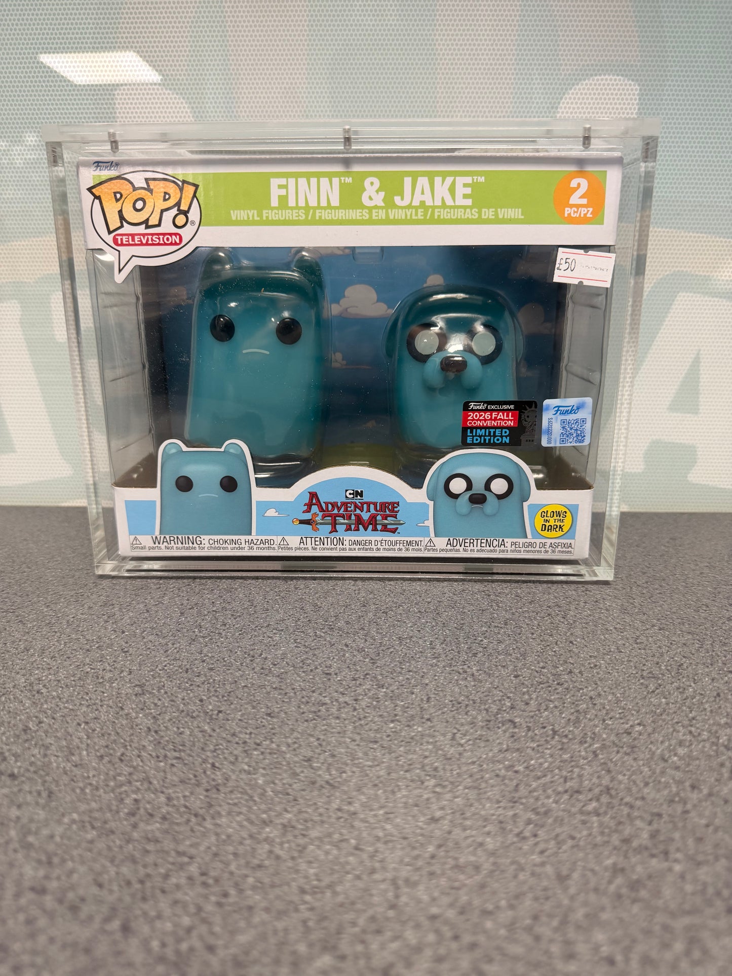 Front of Finn and Jake Adventure Time Funko Pop! 2-pack showing glow and 2026 Fall Convention stickers