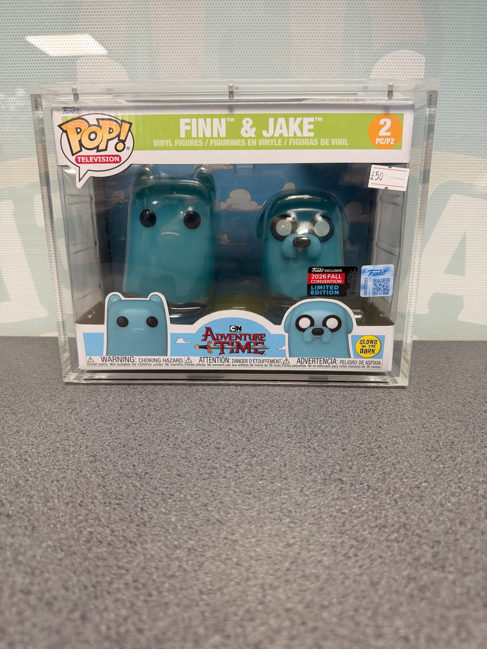 Front of Finn and Jake Adventure Time Funko Pop! 2-pack showing glow and 2026 Fall Convention stickers